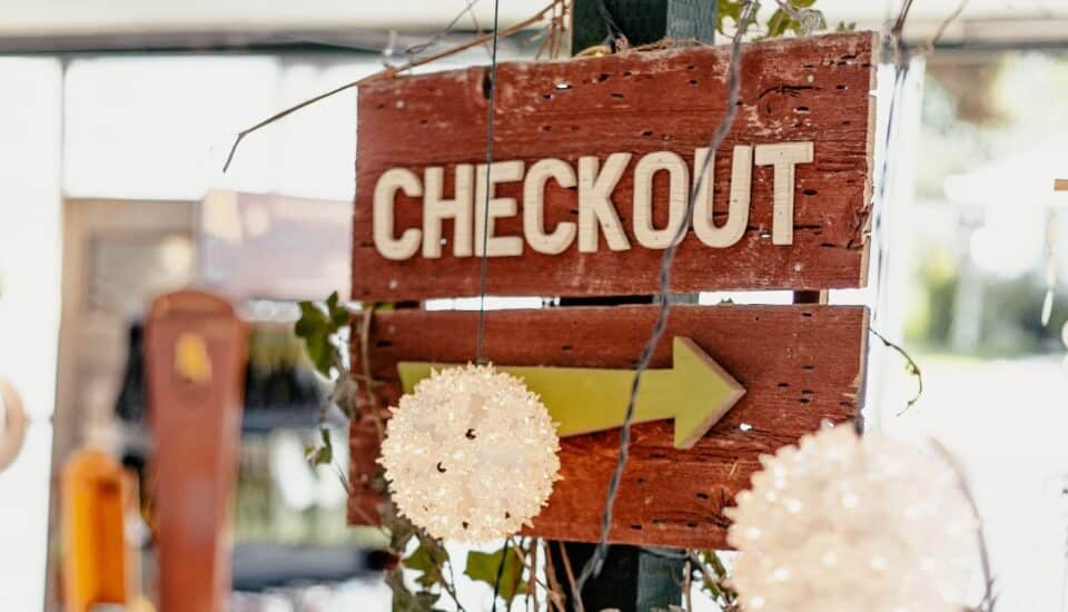 store sign pointing to checkout area