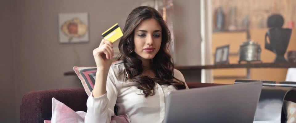 woman shopping on an ecommerce website with a credit card