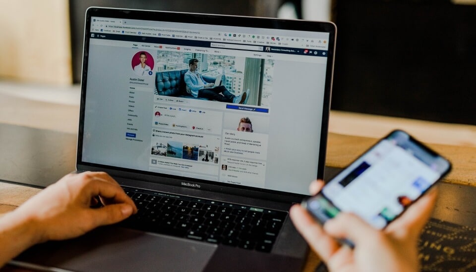 man using social media on a laptop to boost PR results