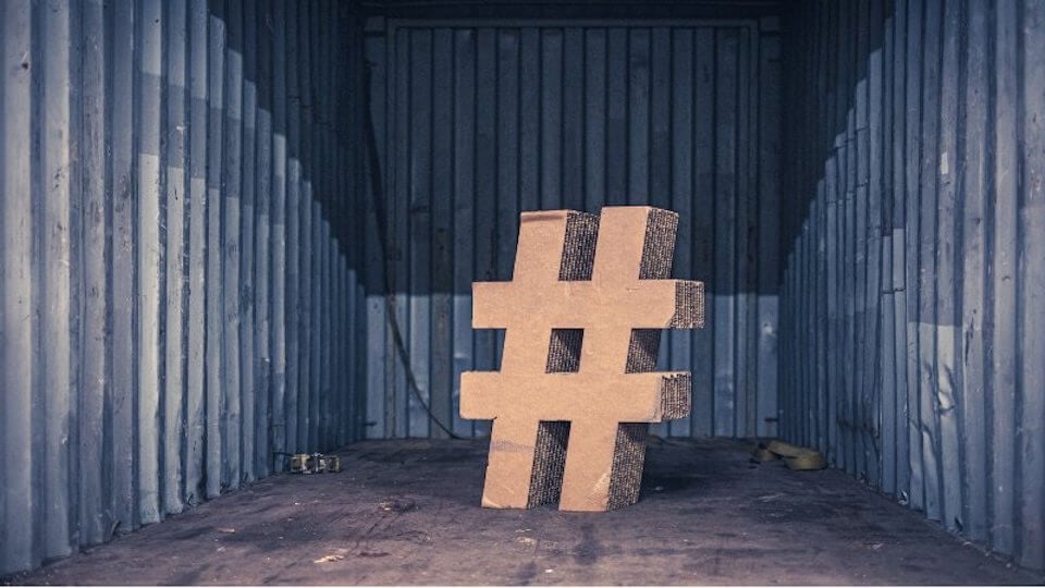 large hashtag in an empty room to show how social media helps with demand generation