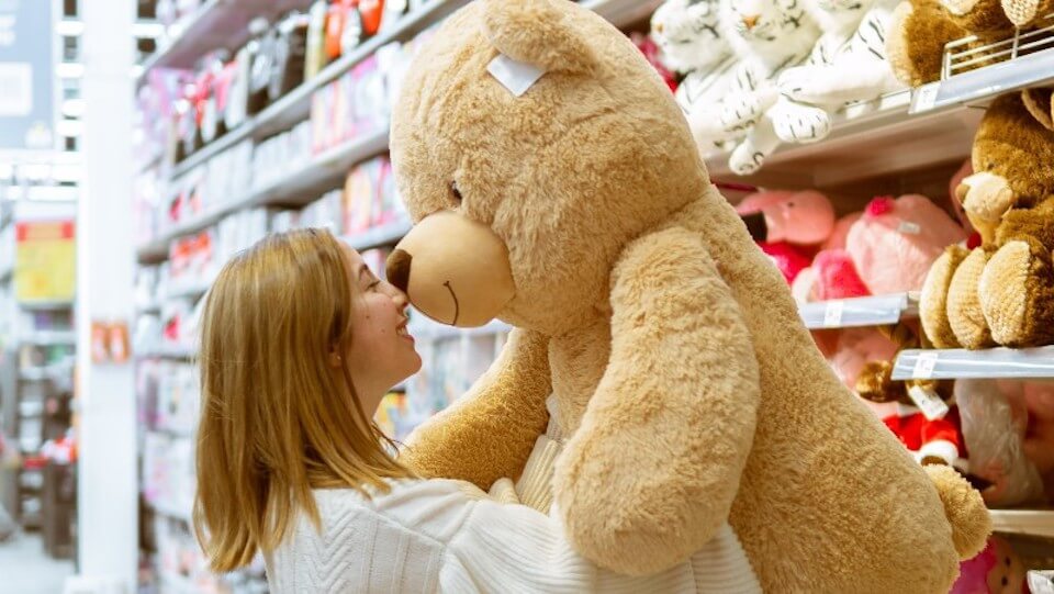 woman holding a large teddy bear