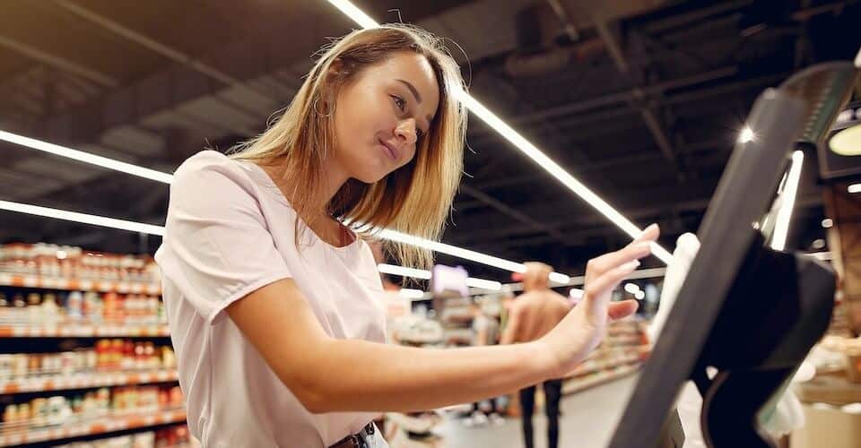 woman shopping at keyosk to represent customer lifetime value