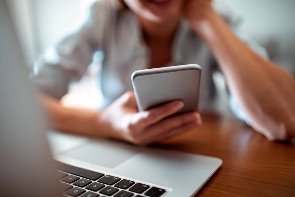 woman watching video on mobile phone about wast to generate leads