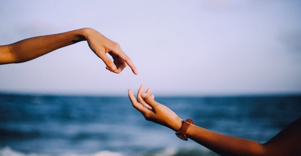 two fingers about to touch representing customer touchpoints