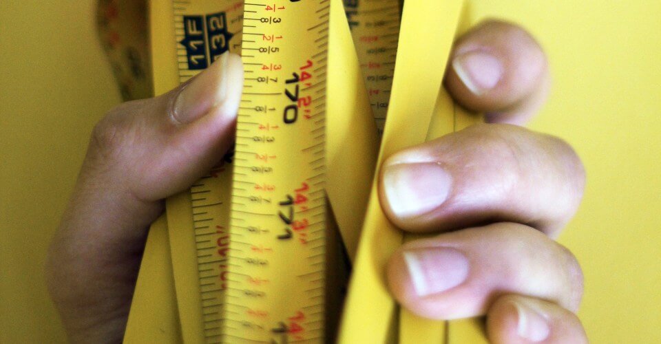 hand holding measuring tape