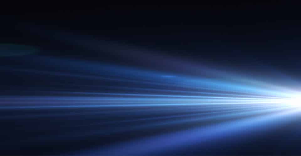 glowing white headlight on a dark blue background
