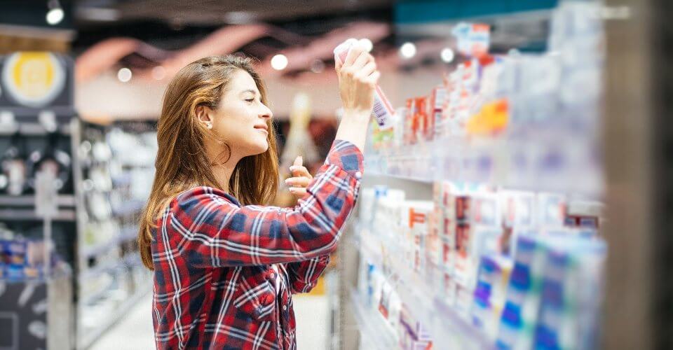 woman buying consumer packaged goods (CPG) in a store