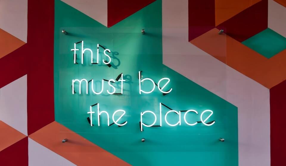 neon sign that reads - this must be the place