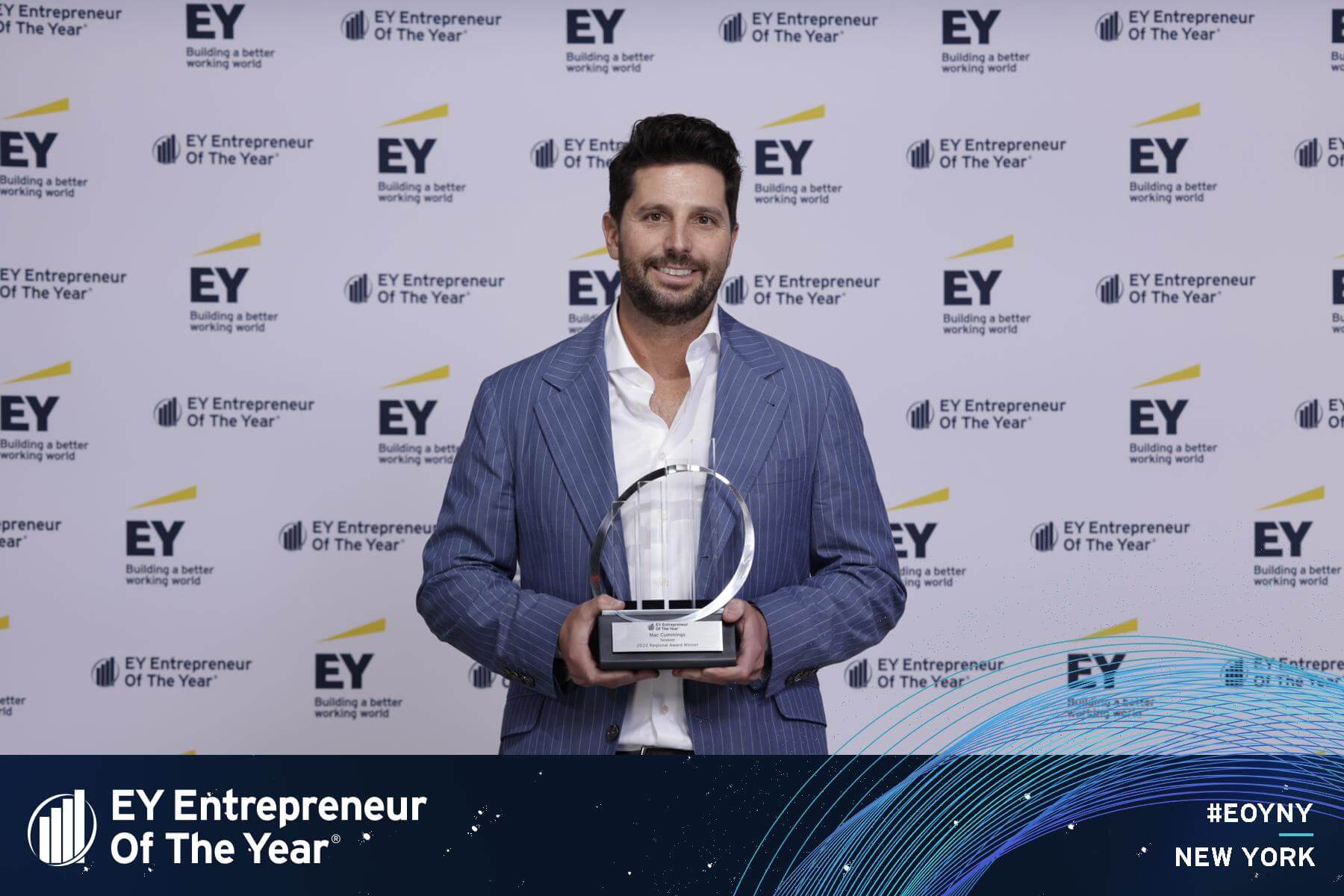 Photo of MacLaren “Mac” Cummings receiving the EY Entrepreneur Of The Year award