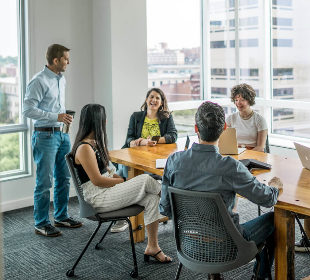 Terakeet employees smiling as they discuss owned asset optimization (OAO)