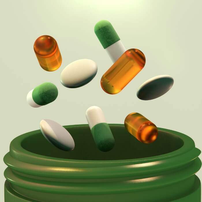 Pill bottle with different pills coming out
