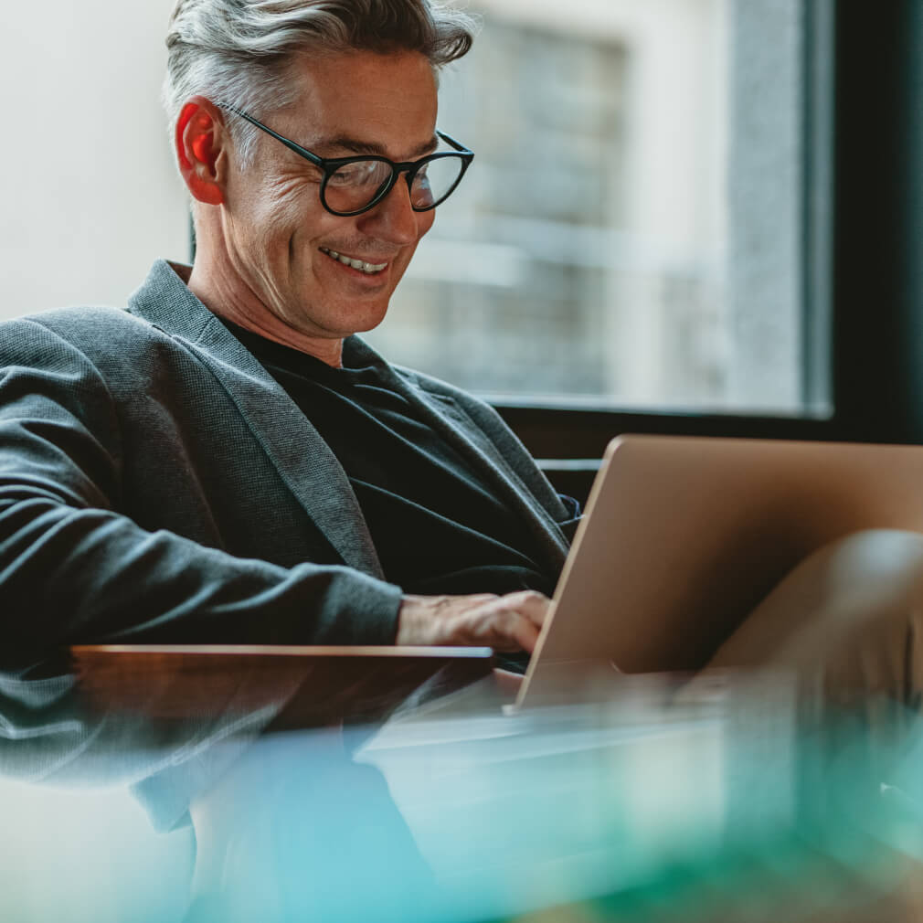 Person smiling at a computer