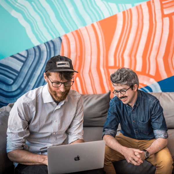 Terakeet employees work together on a computer