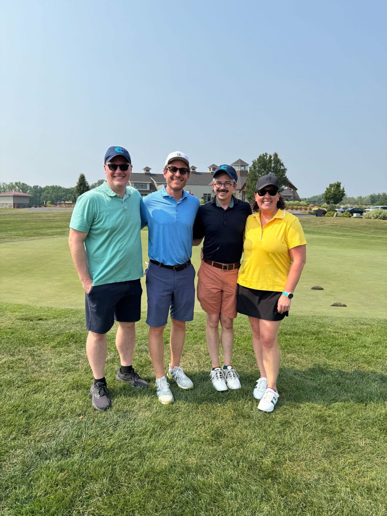 Four golfers pose and smile at the 2025 Cause For The Cuse golf tournmanet