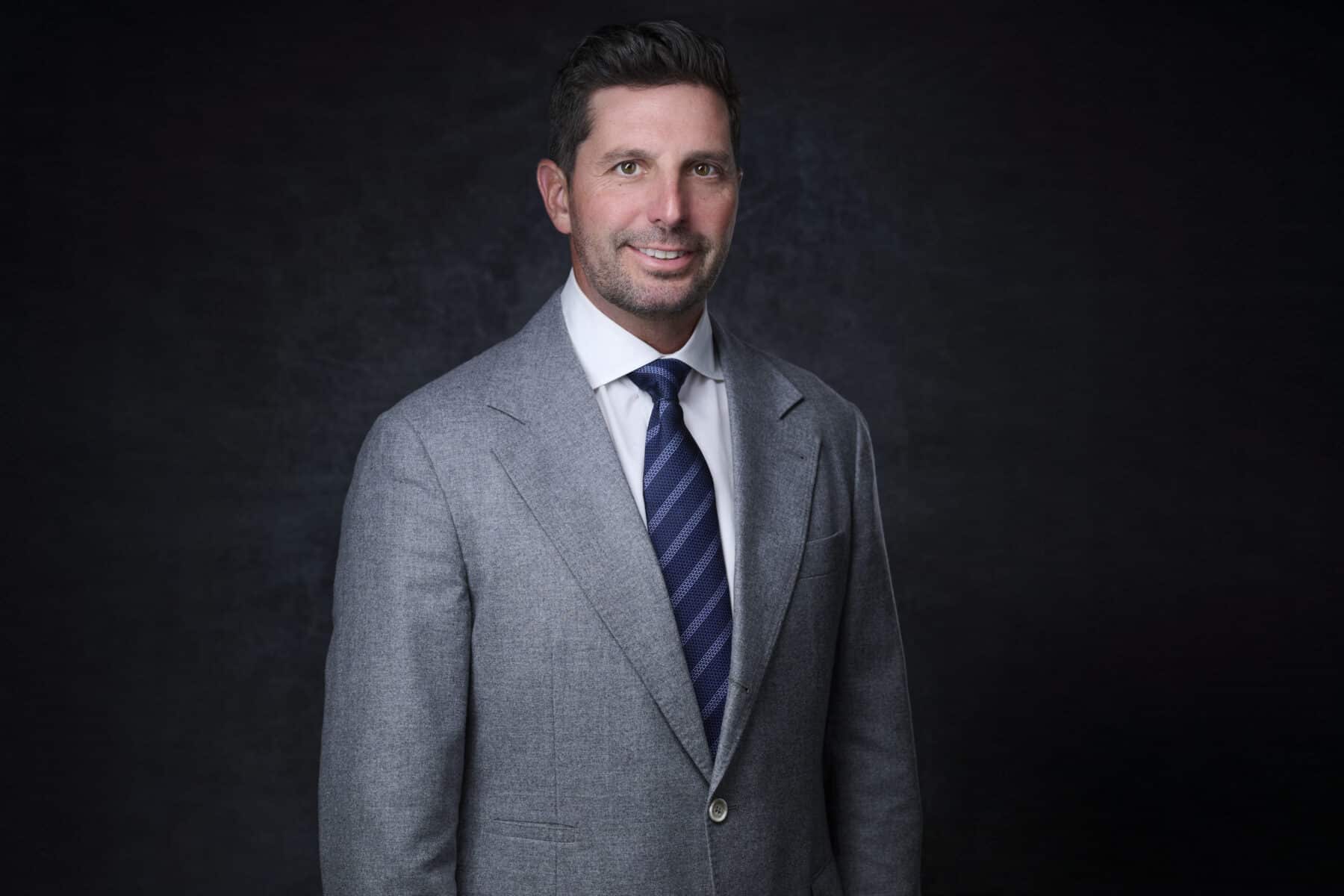 MacLaren "Mac" Cummings smiles in a suite and tie