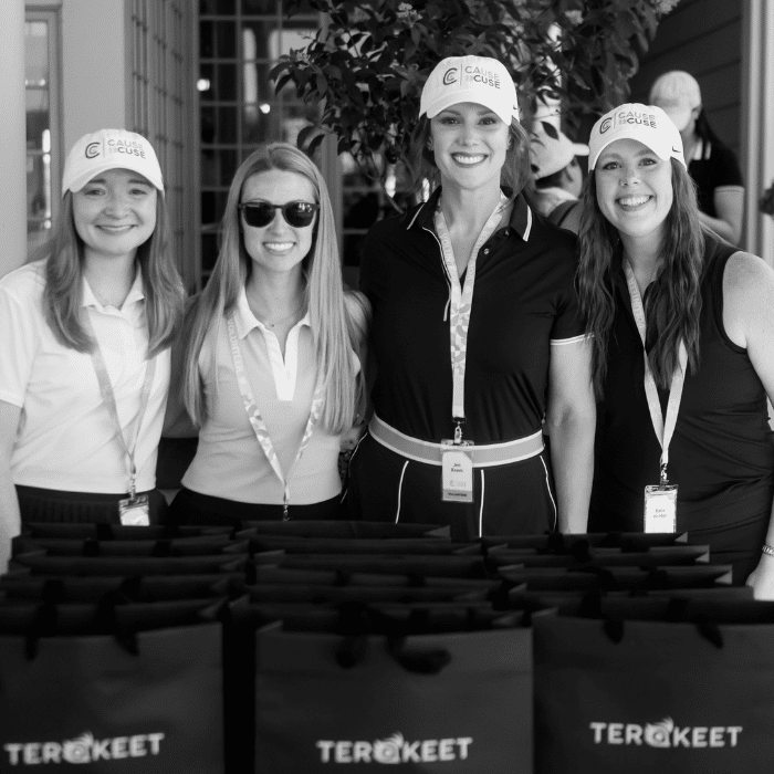 Four women stand behind Terakeet gift bags, smiling